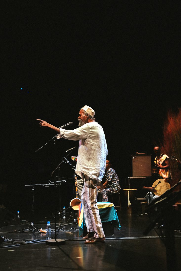 menwar mid-song, arm outstretched