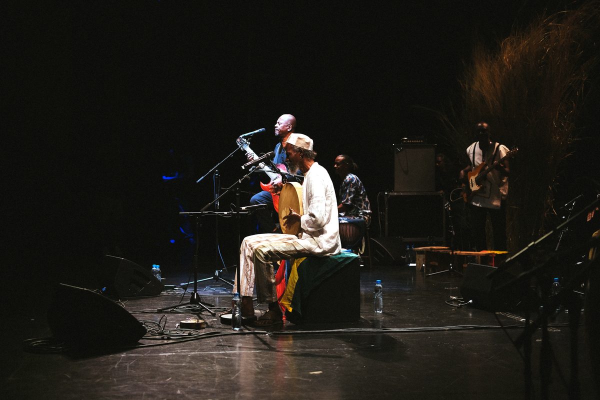 menwar seated in a pool of light