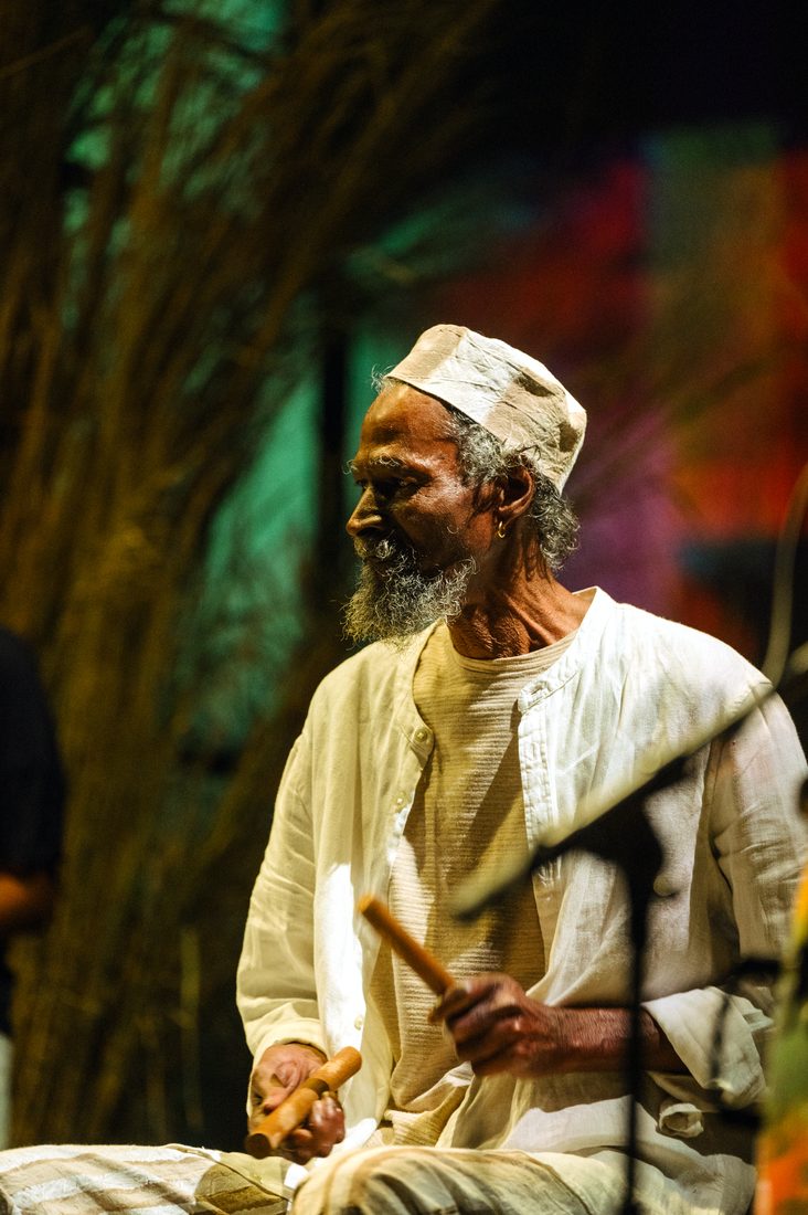 menwar in profile with percussion sticks